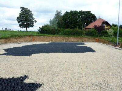 Riding arena grids from novus:HM on paddock filled with round pebbles